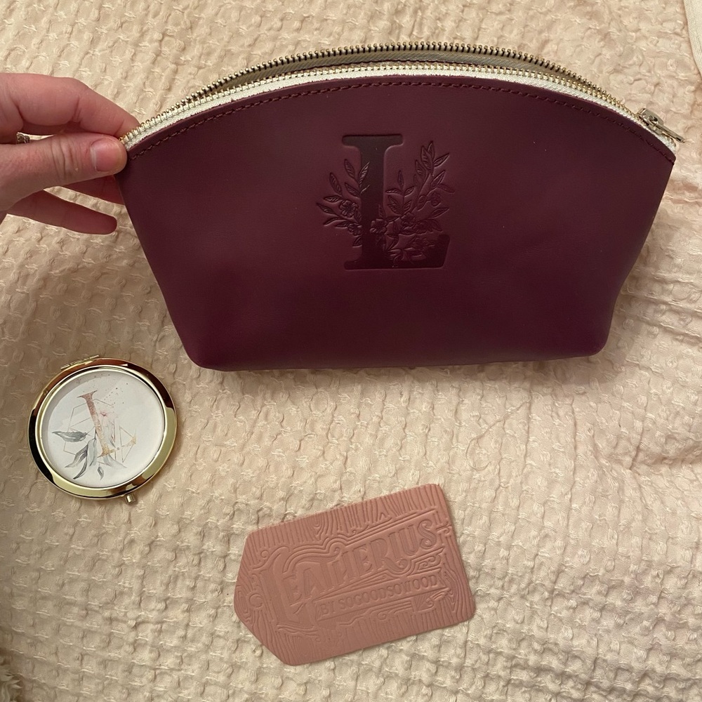 NWT Genuine leather monogrammed “L” makeup case in wine/burgundy